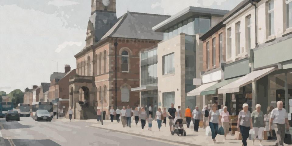 A town hall clock tower above a busy high street